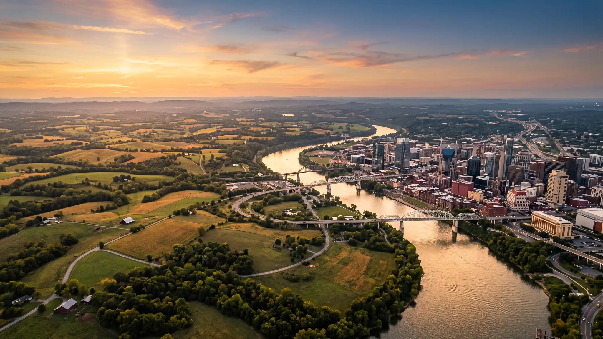 Junk removal service areas in Middle Tennessee | Music City Junk Aerial view of the Cumberland River winding past the Nashville skyline and Middle Tennessee farmland at sunset
